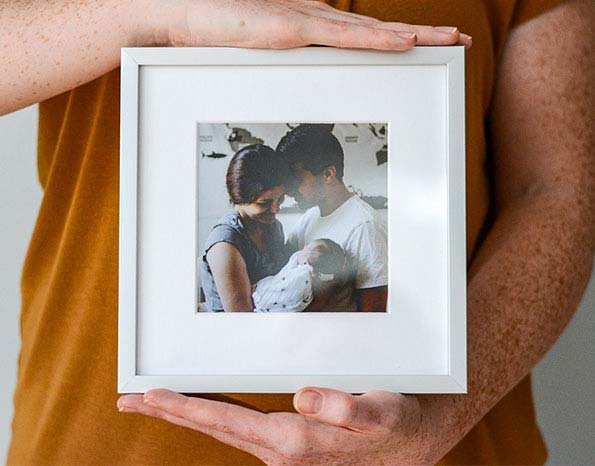 person holding frame in arms