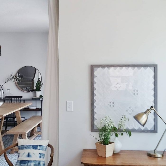 framed quilt in living area