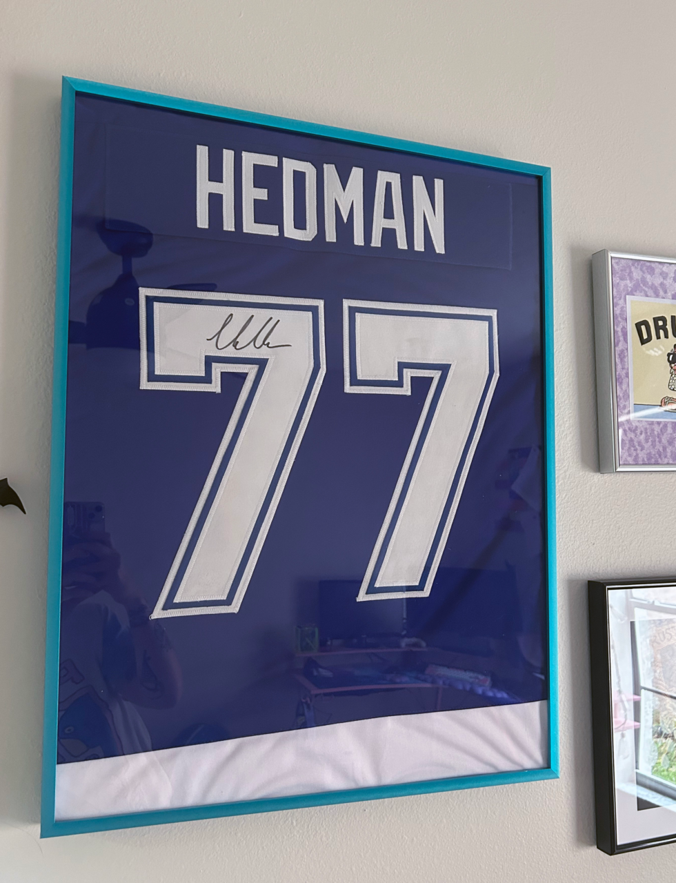 framed hockey jersey in a blue picture frame