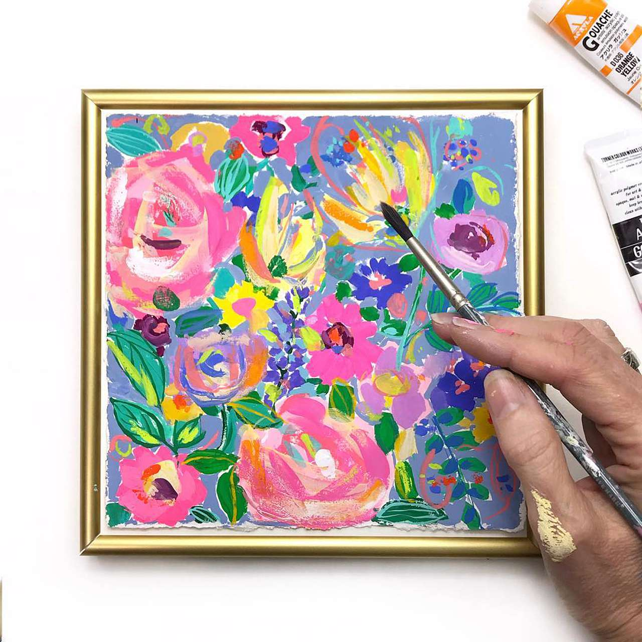 colorful art in a gold picture frame