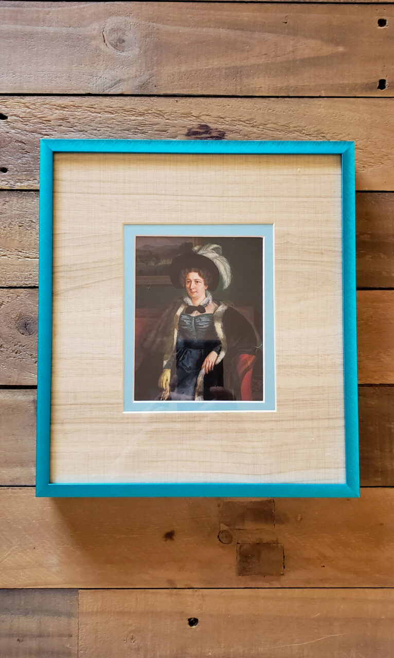 bright blue picture frame with wood grain matboard