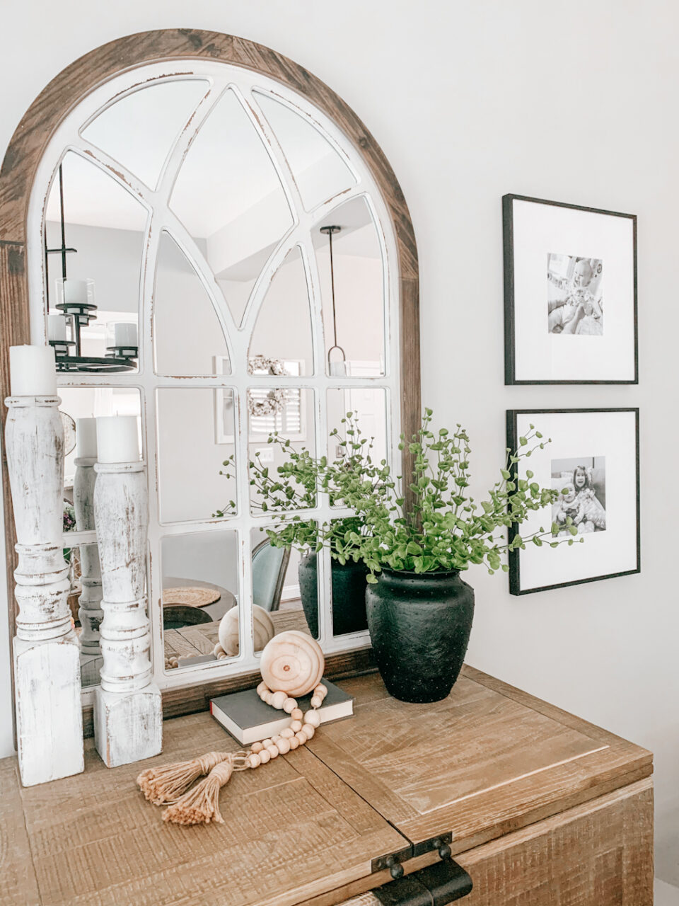 mirror next to black frames with black and white photography