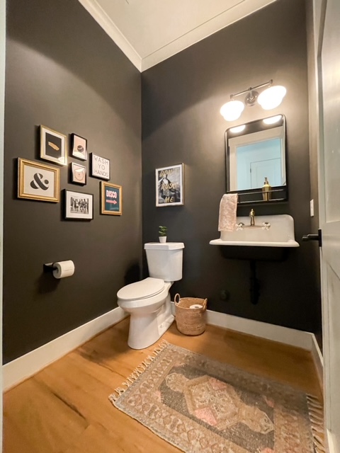 ornate picture frames in dark bathroom