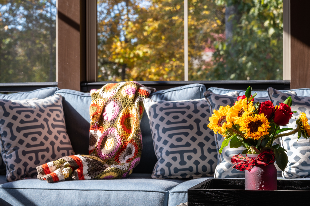 screened in porch with cozy couch