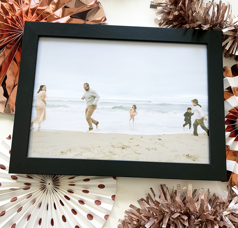 black picture frame of family on the beach