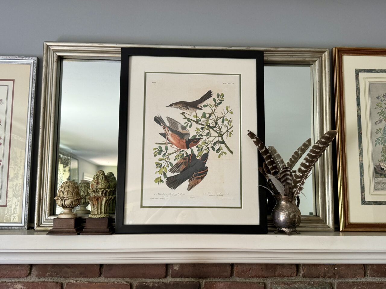 black picture frame on a mantel 