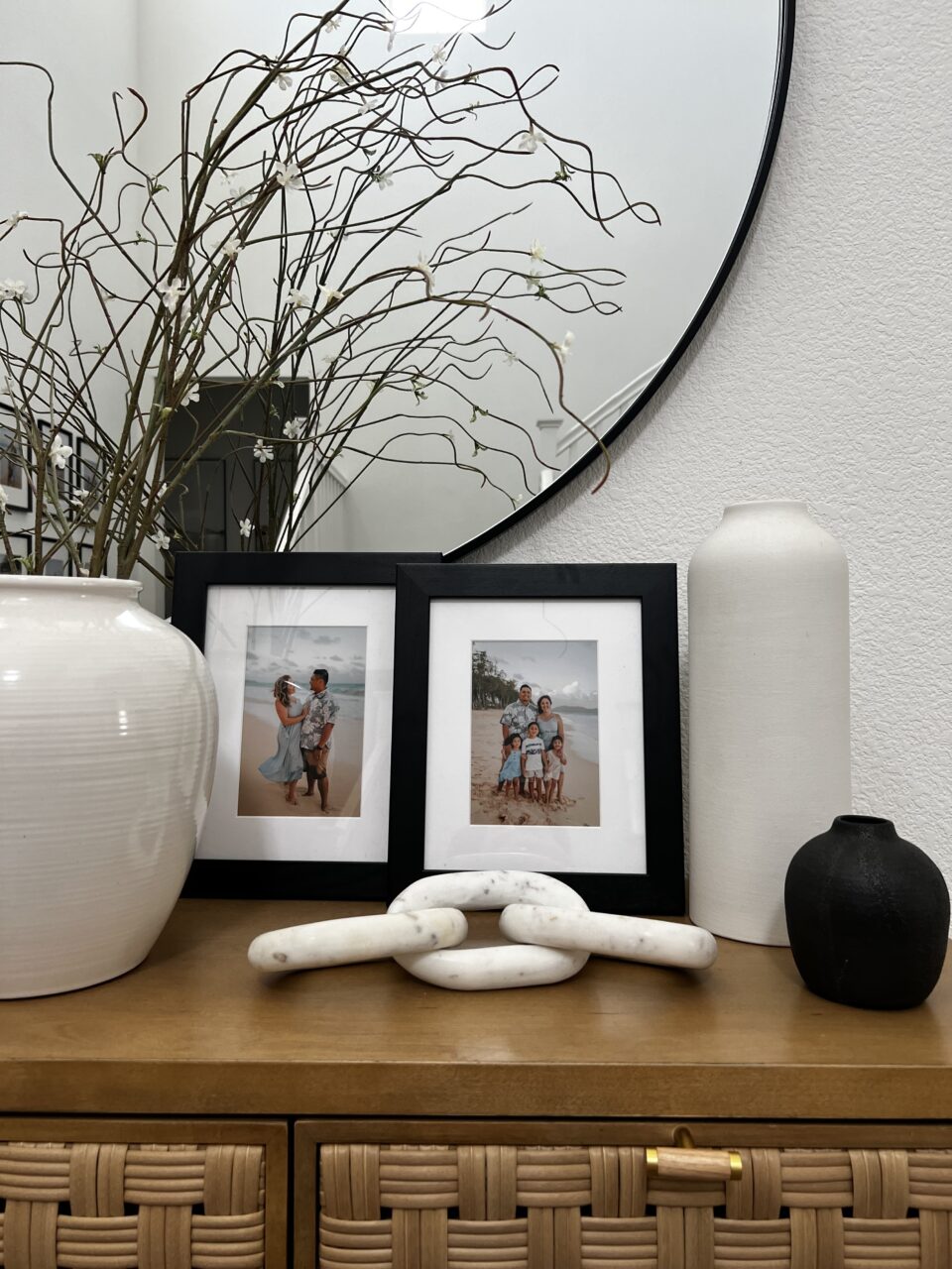 family photos in black frame on table