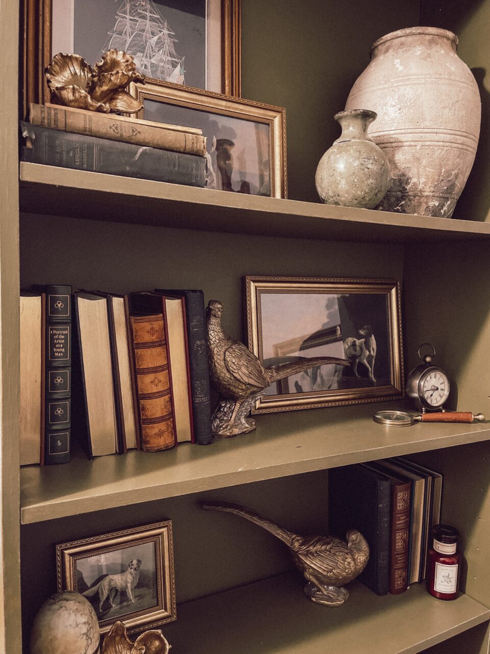 gold picture frames on a shelf